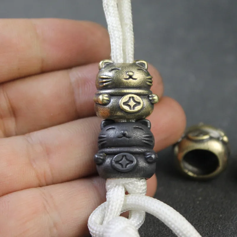 Couteau en laiton pour mascotte de chat porte-bonheur, perles EDC pour l’extérieur, accessoires paracorde, lanière tissée, pendentifs, bijoux, corde de parapluie Couteau en laiton pour mascotte de chat porte-bonheur, perles EDC pour l’extérieur, accessoires paracorde, lanière tissée, pendentifs, bijoux, corde de parapluie