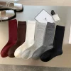 Chaussettes unisexes pour hommes et femmes, Tube haut en coton, chaussettes de sport de haute qualité, solides, noires et blanches